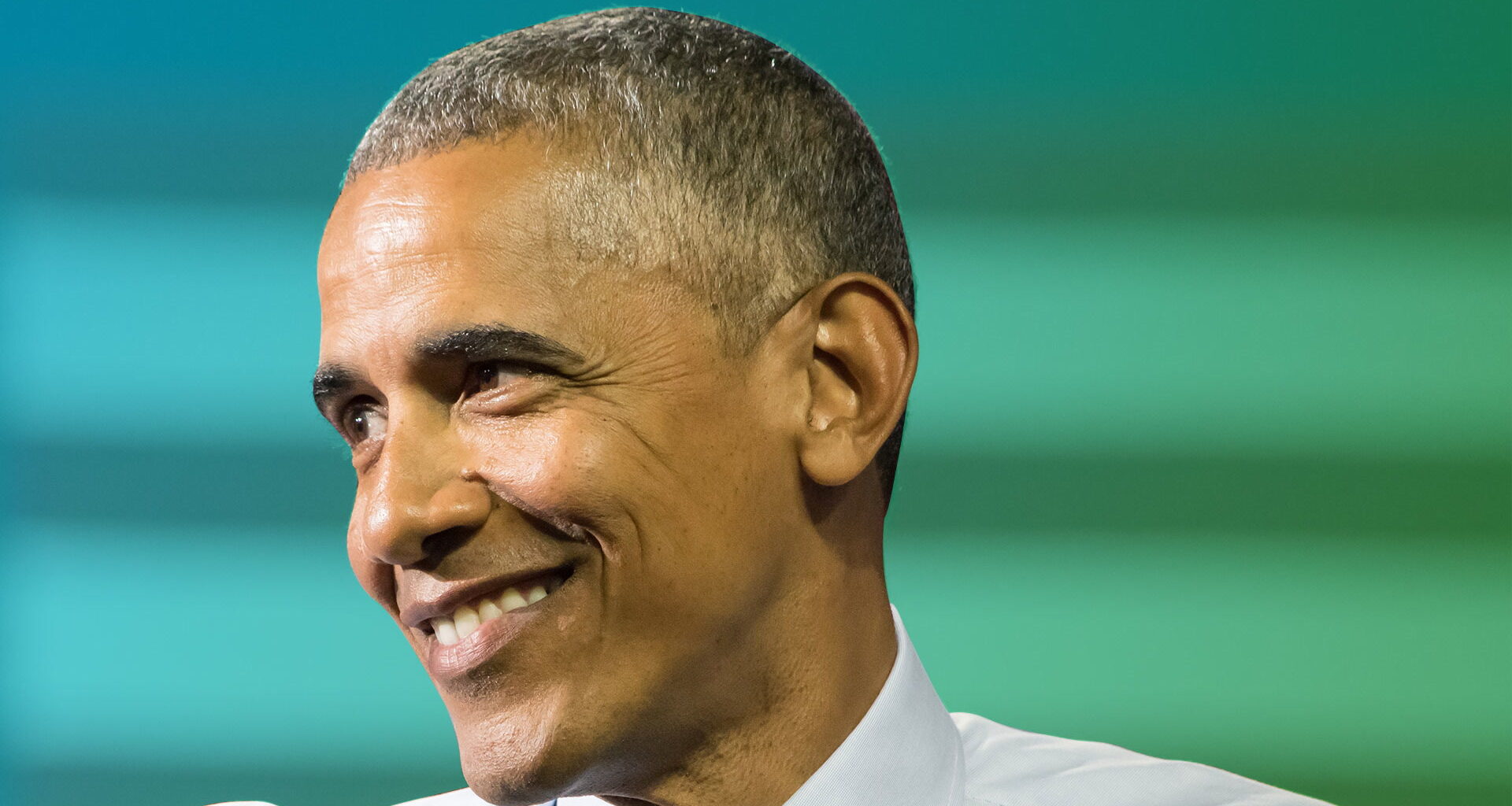 Former president Barack Obama smiling in a shot to illustrate his current wealth and net worth after politics.