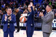 Dallas Wings general manager Curt Miller (left) and CEO Greg Bibb (right) applaud guard...