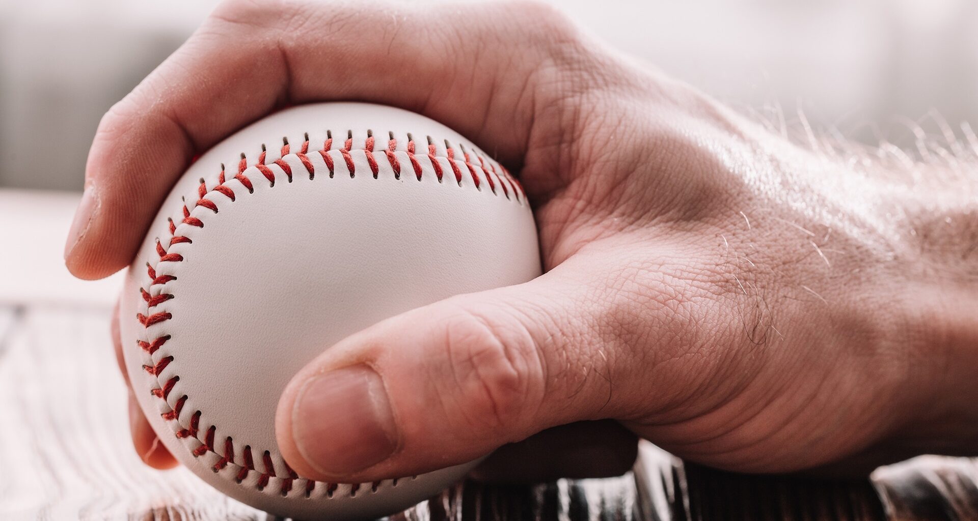 Male hand grabbing a baseball stock photo