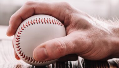 Male hand grabbing a baseball stock photo