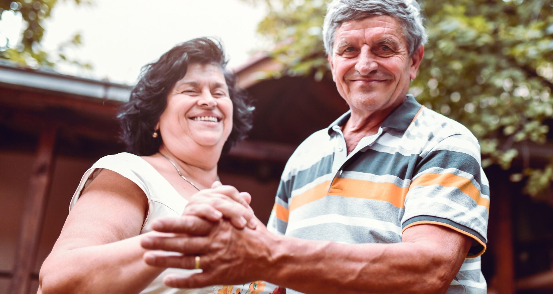 Happiness Expressed By Senior Husband And Wife Through Outdoor Dance In Backyard stock photo