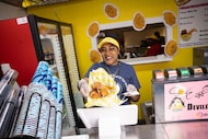 Manager Lynda Cook serves the Wagyu Bacon Cheeseburger Deviled Egg Sliders during the State...