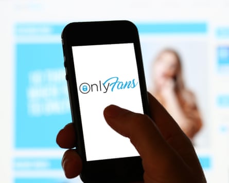 A man looking at OnlyFans website on a computer and mobile phone