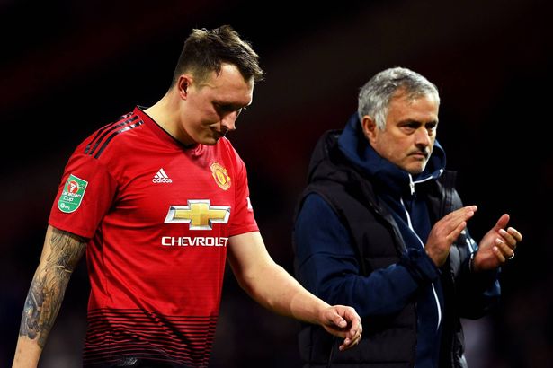 Phil Jones walks alongside Jose Mourinho