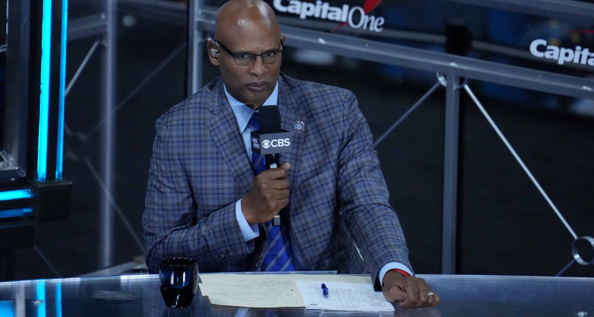 CBS announcer Clark Kellogg holds the microphone during a game