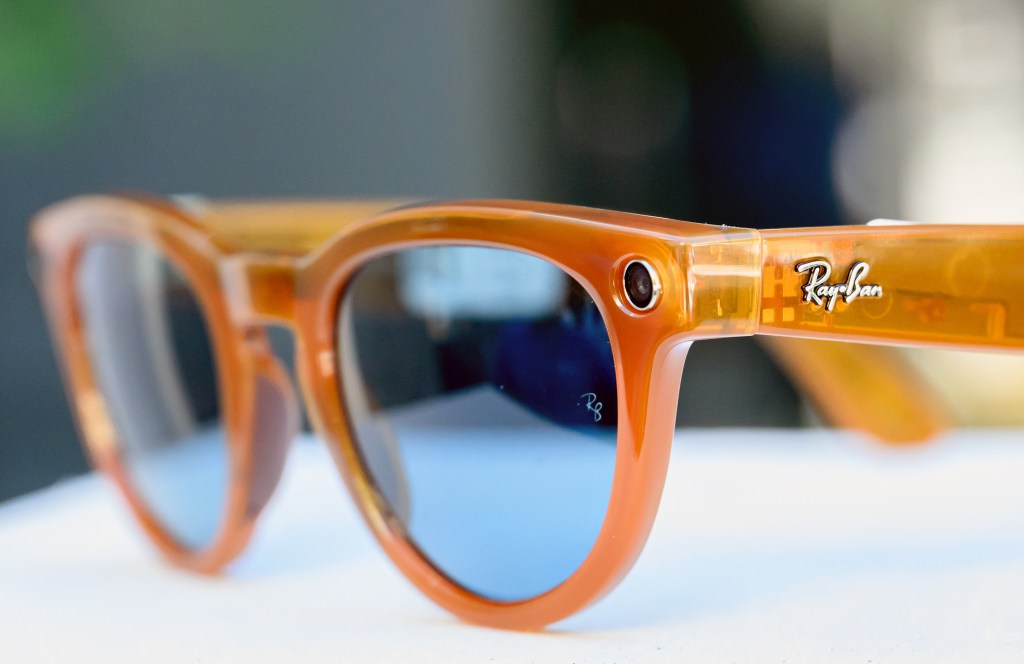 Close-up of orange Ray-Ban Meta smart glasses.
