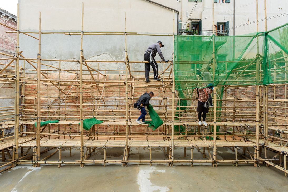 Workers set up a bamboo scaffold inside the Hong Kong pavilion at the 2025 Venice Biennale. The structure is part of a showcase about Hong Kong's threatened heritage and public space.