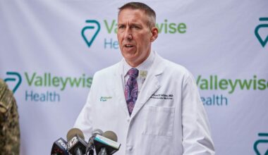 Dr. Michael White, chief clinical officer of Valleywise Health, speaks to the news media outside Valleywise Health Medical Center in Phoenix on Tuesday, Feb. 22, 2022. (Photo by Alex Gould/Cronkite News)