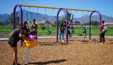 Families play on the swings and other playground equipment during the ribbon-cutting for the new Laveen Heritage Park at 71st Avenue and Meadow Loop Road on Monday, Sept. 8.