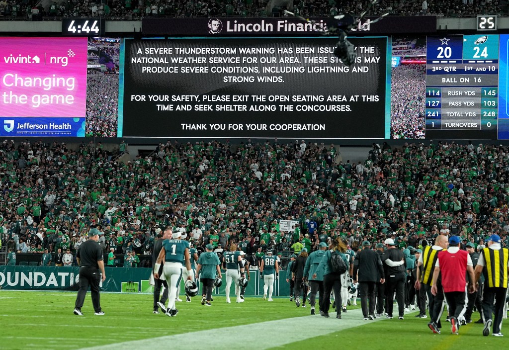 The Philadelphia Eagles exit the field due to lightning in the area to cause a weather delay in the third quarter in the game at Lincoln Financial Field on September 04, 2025 in Philadelphia, Pennsylvania. 