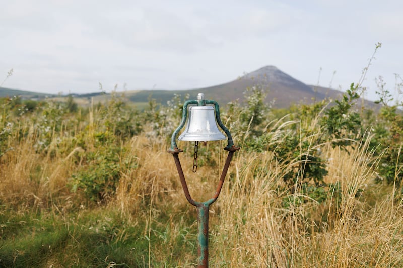 The silver bell, once used by golfers, hangs in the middle of the trees. Photograph: Dan Dennison