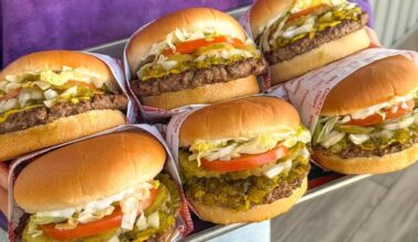 A set of six stuffed hamburgers on a tray.