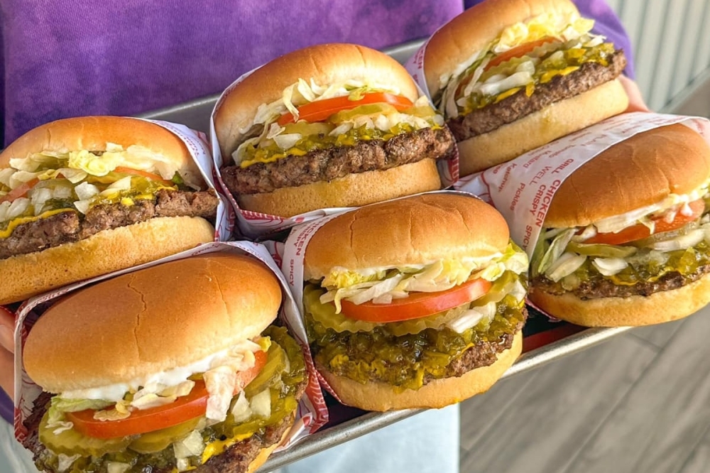 A set of six stuffed hamburgers on a tray.