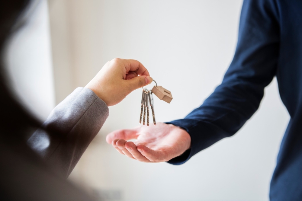 person hands another person keys