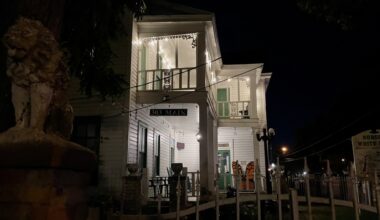 Business in Old Town Spring at night with a statue to the left