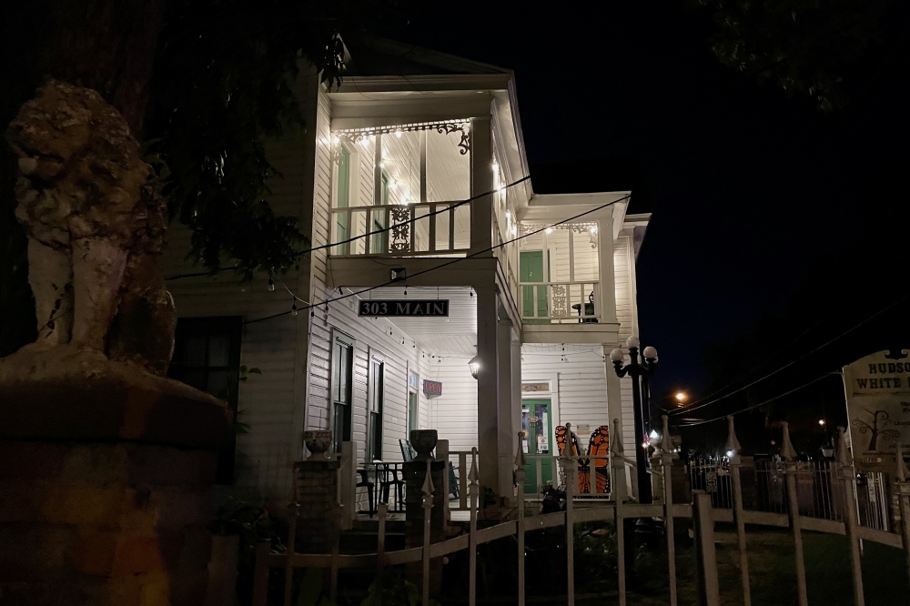 Business in Old Town Spring at night with a statue to the left