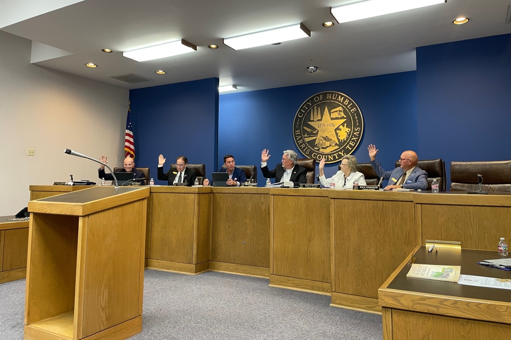 Humble City Council seated and raising hands to vote