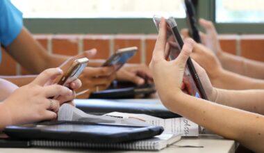 hands of students using phones