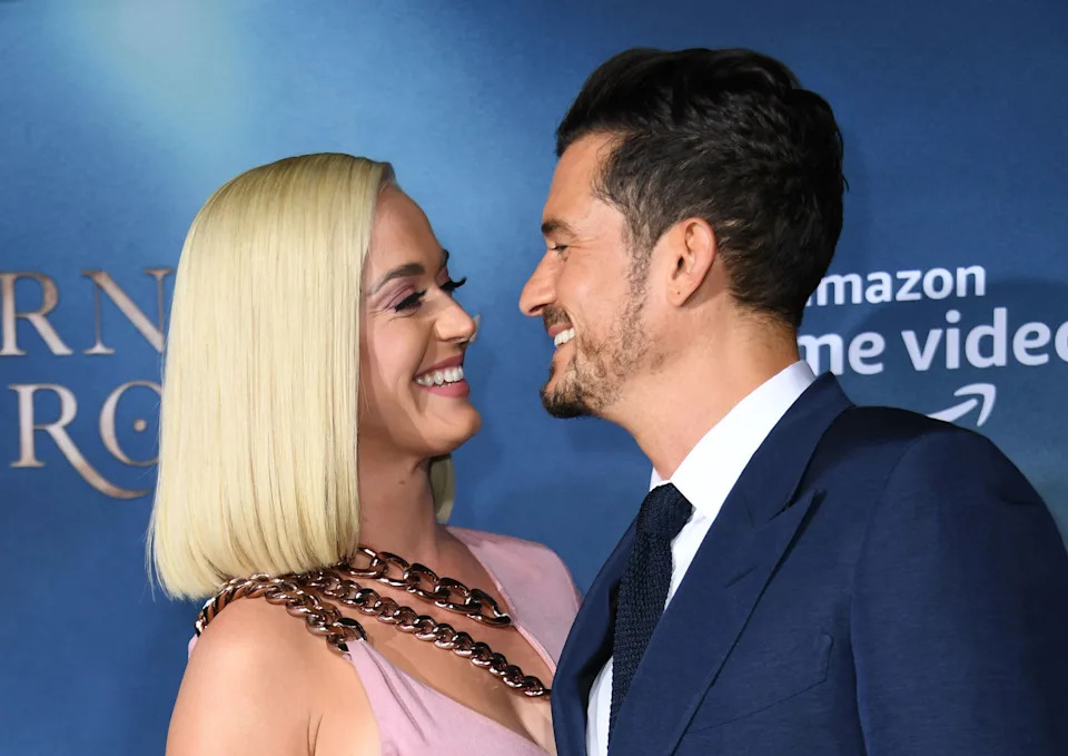 Perry and Bloom smile at each other at a press event.