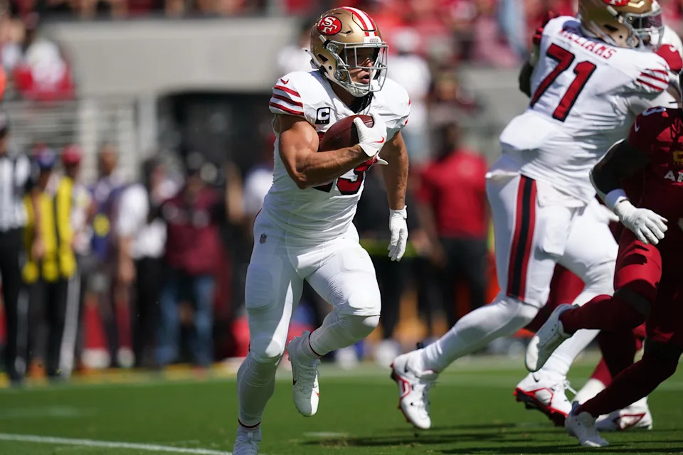 Sep 21, 2025; Santa Clara, California, USA; San Francisco 49ers running back Christian McCaffrey (23) carries the ball against the Arizona Cardinals during the first half at Levi's Stadium.