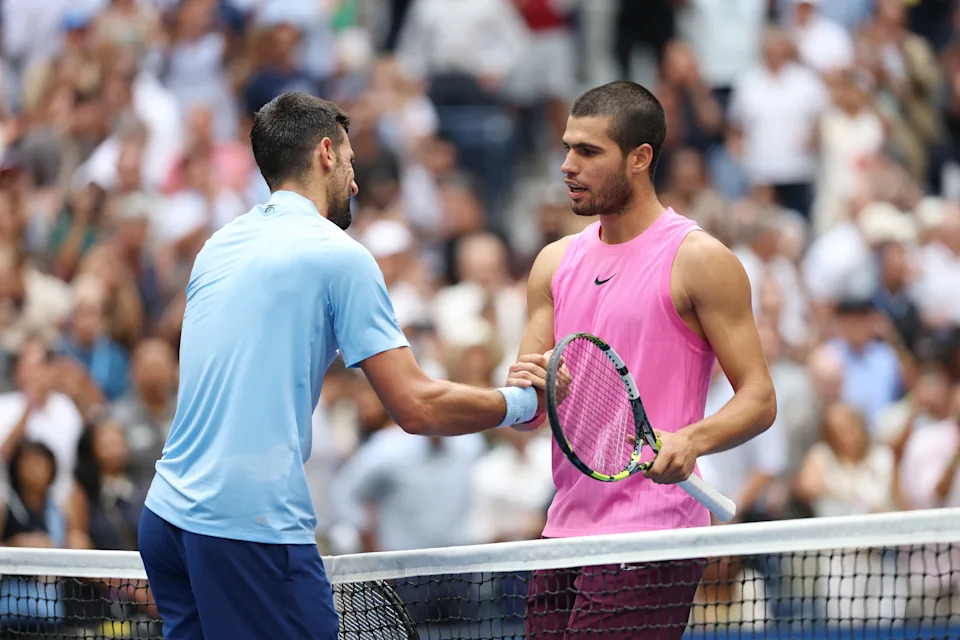NEW YORK, NEW YORK - SEPTEMBER 05: Carlos Alcaraz of Spain (R) greets Novak Djokovic of Serbia (L) following their Men's Semifinal match on Day Thirteen of the 2025 US Open at USTA Billie Jean King National Tennis Center on September 5, 2025 in the Flushing neighborhood of the Queens borough of New York City. (Photo by Clive Brunskill/Getty Images)