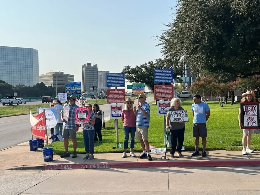 A group gathers for a weekly prayer vigil outside the Dallas ICE office.