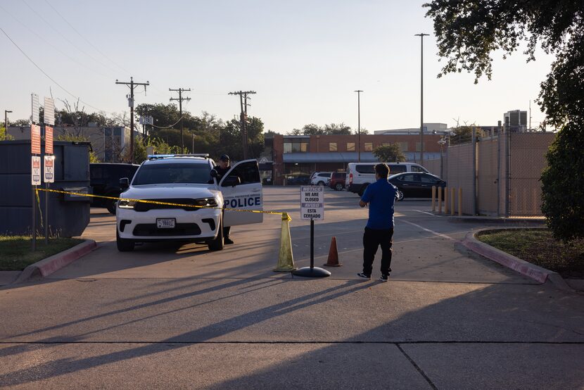 A man walks up to a police car outside of  the U.S. Immigration and Customs Enforcement...