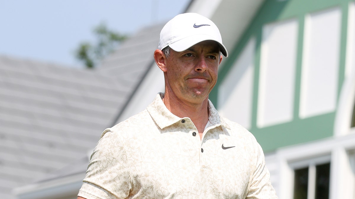 Rory McIlroy smirks on course