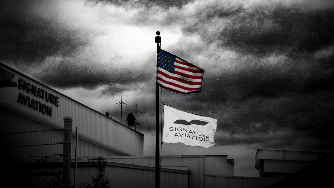 U.S. and Signature Aviation flags fly outside Signature Aviation's Newark Liberty International Airport terminal.