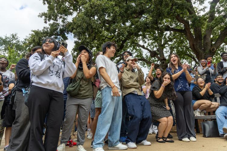 Attendees react to one of the contestants during a performative male contest Sept. 24 at the Central Library mall.