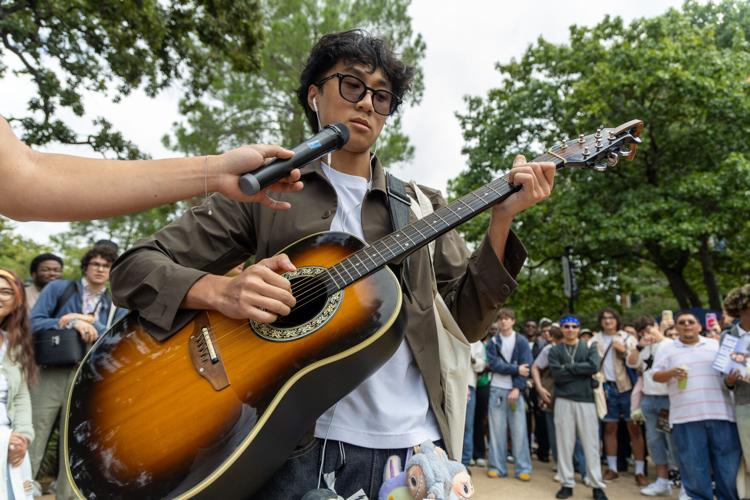 Biology pre-dental senior Jeff Nguyen sings and plays the guitar during a performative male contest Sept. 24 at the Central Library mall. 