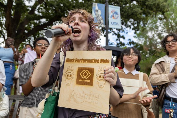 History freshman Sadie McQuay speaks into the microphone during a performative male contest Sept. 24 at the Central Library mall.