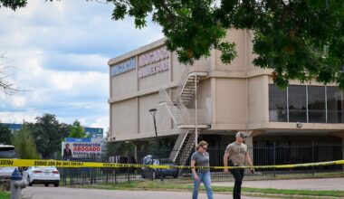 Investigators worked the scene near a building where authorities say 29-year-old Joshua Jahn fired indiscriminately from the rooftop toward a Dallas immigration field office last week.