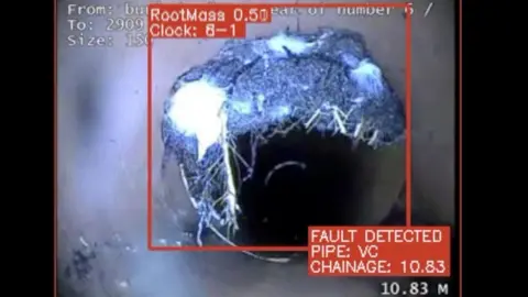 SWW A still image of CCTV of a sewer pipe, where AI has drawn a red box around a block of roots that are growing into the pipe. A red box reads 'fault detected'