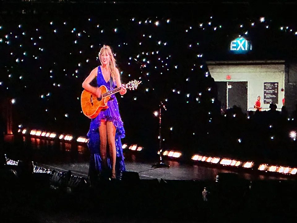 Taylor Swift wore a new blue and purple dress during her surprise, acoustic set during her Eras Tour concert at Hard Rock Stadium in Miami on Saturday, Oct. 19, 2024.