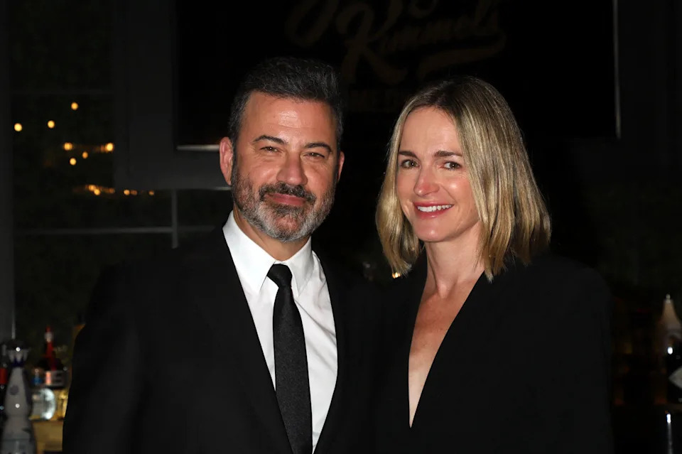 Jimmy Kimmel poses with his wife Molly McNearney, both dressed in black, at an evening event.