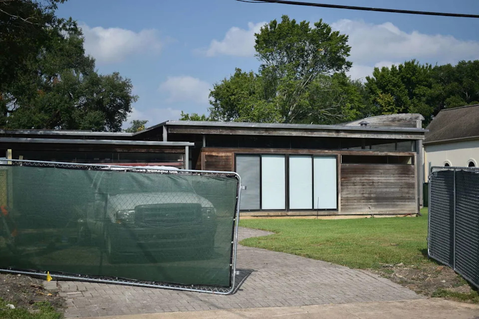 Construction fencing and equipment surrounds the home of Victor Lundy on September 18, 2025, in Bellaire, Texas. The home is allegedly slated for demolition. (Gwen Howerton/Chron.com)