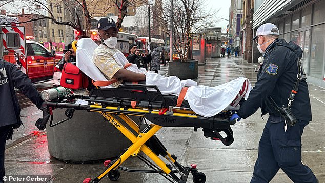 Images showed first responders wore face coverings and gloves as they moved the patients into ambulances