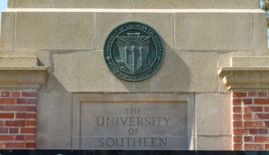 The emblem for the University of Southern California is mounted at a campus entrance in Los Angeles Tuesday, April 16, 2024. (AP Photo/Damian Dovarganes)