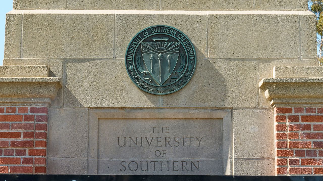 The emblem for the University of Southern California is mounted at a campus entrance in Los Angeles Tuesday, April 16, 2024. (AP Photo/Damian Dovarganes)