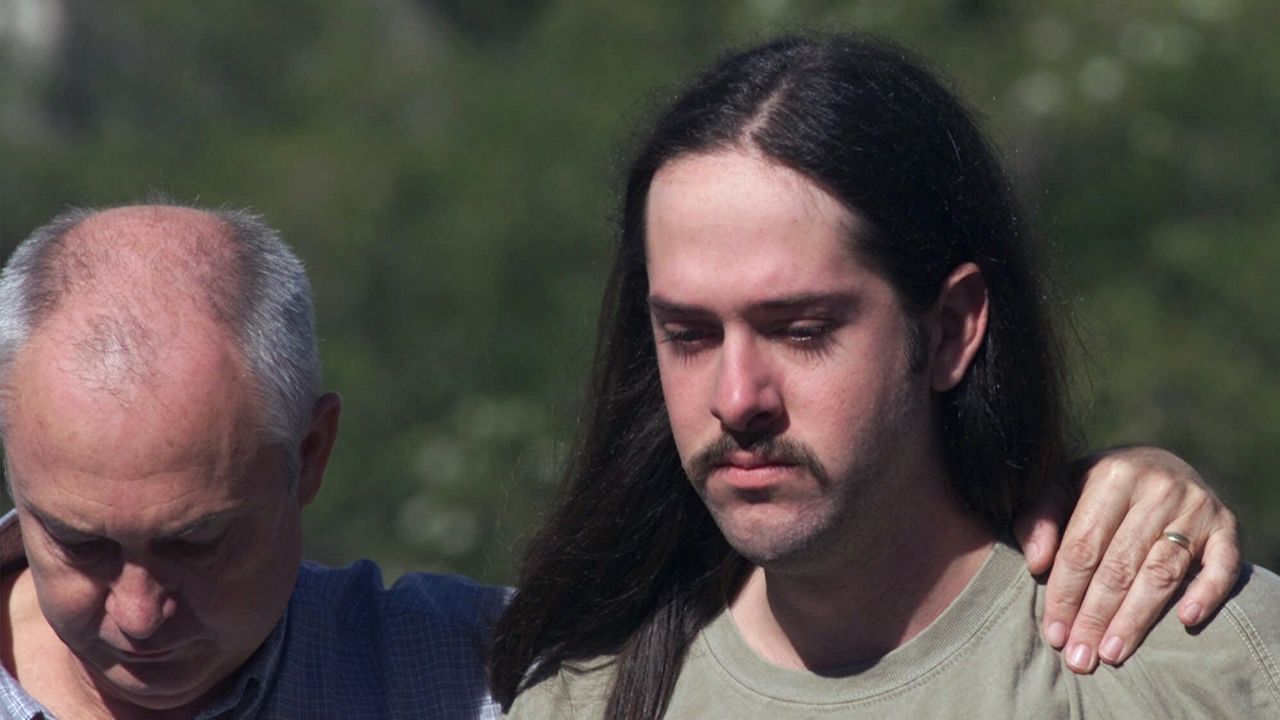 Jimmy Welborn, left, escorts his son Forrest away from the Travis County Jail on Friday, Dec. 10, 1999, in Austin, Texas. (AP Photo/Harry Cabluck)
