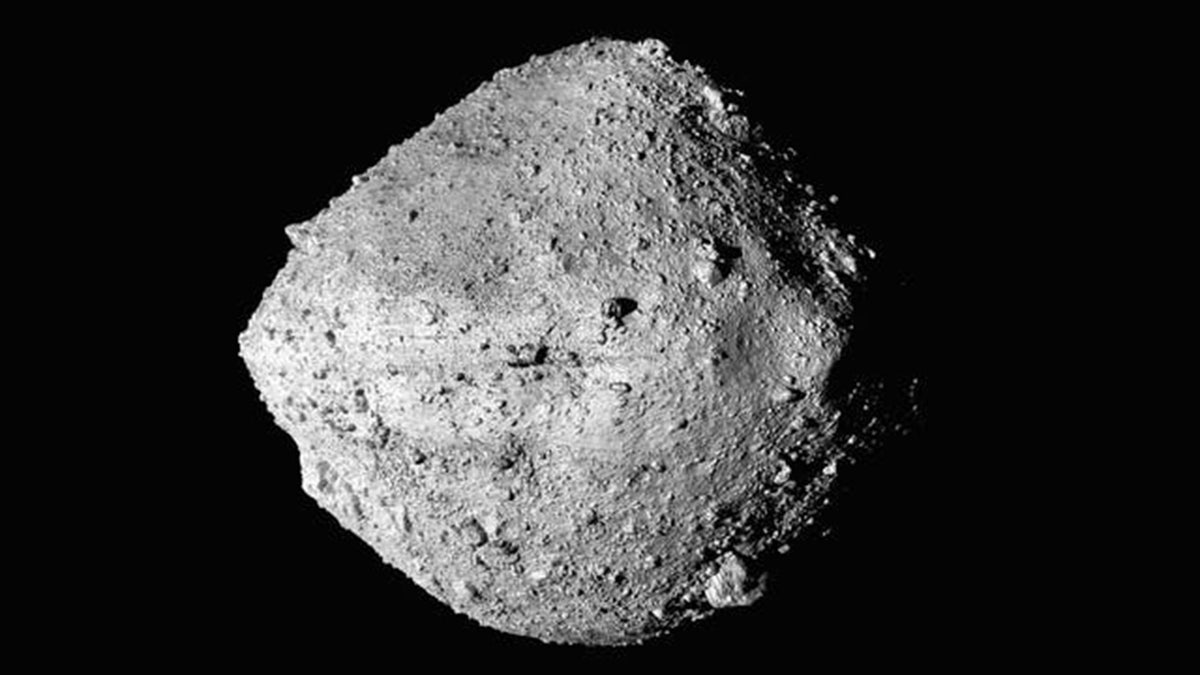 The Grey asteroid Bennu floating in space