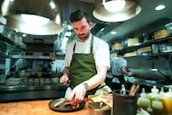 Chef RJ Yoakum prepares dry-aged duck breast at Georgie in this photo from March 2024....
