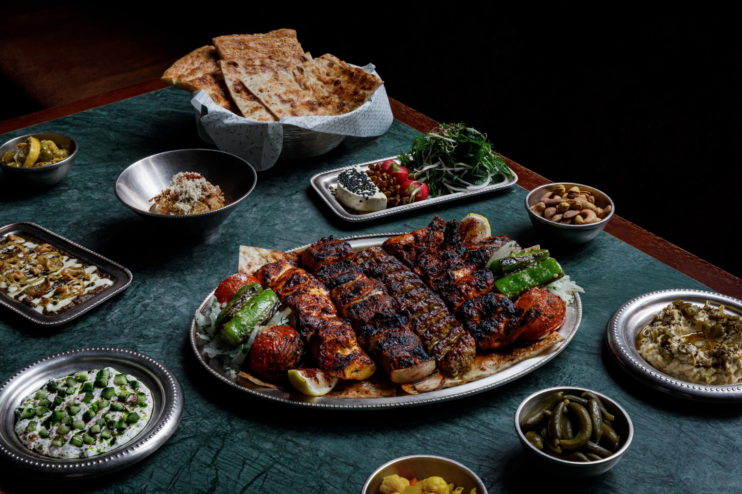 Plate of kebabs over flatbrad at Berenjak