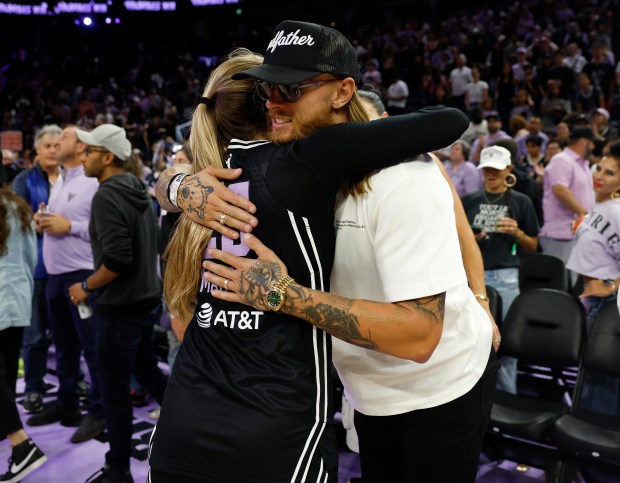 Golden State Valkyries' Kate Martin (20) hugs San Francisco 49ers' George Kittle after their 75-63 win over the Indiana Fever at the Chase Center in San Francisco, Calif., on Sunday, Aug. 31, 2025. (Nhat V. Meyer/Bay Area News Group)