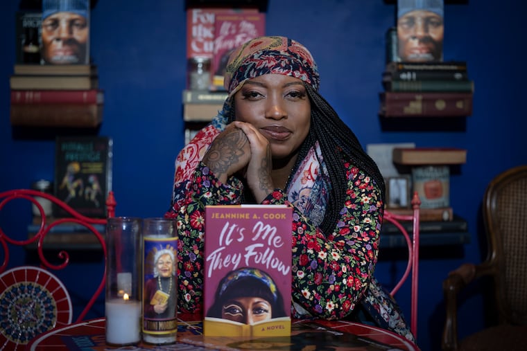 Author Jeannine Cook poses with her book on Monday, Sept. 15, 2025, at the newly refurbished Harriett's Bookshop in Philadelphia.