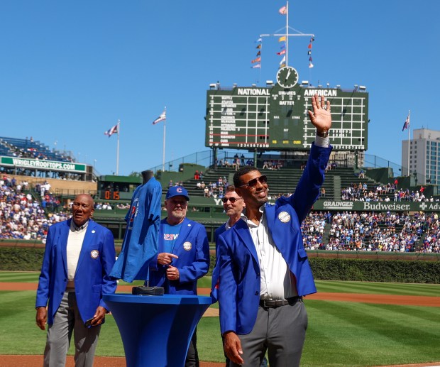 Chicago Cubs Hall of Famer Derrek Lee waves to the crowd after receiving his blue jacket at Wrigley Field on Sept. 7, 2025, in Chicago. (Stacey Wescott/Chicago Tribune)