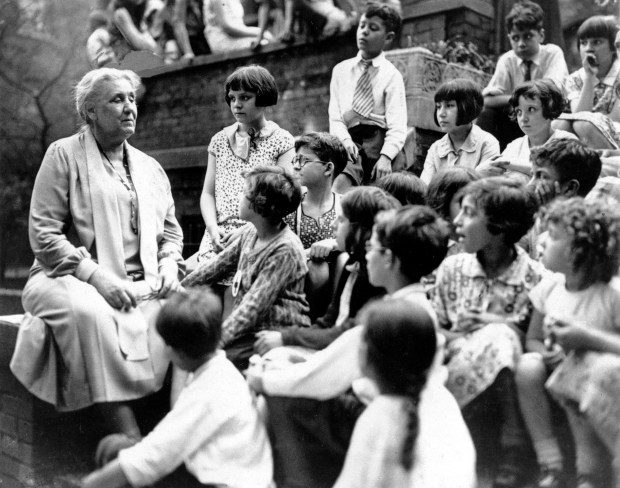 Jane Addams talks with a group of young people who are visiting her at Hull House in Chicago, on May 24, 1935. (AP)