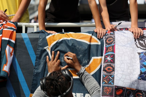 Chicago Bears defensive back Jonathan Owens signs autographs before the...