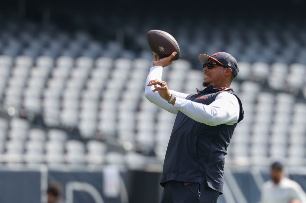 Chicago Bears general manager Ryan Poles throws a football on...